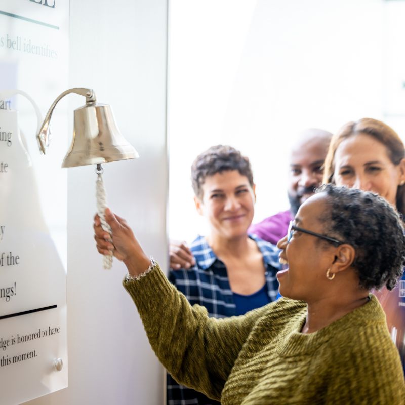 Cancer patient ringing bell.